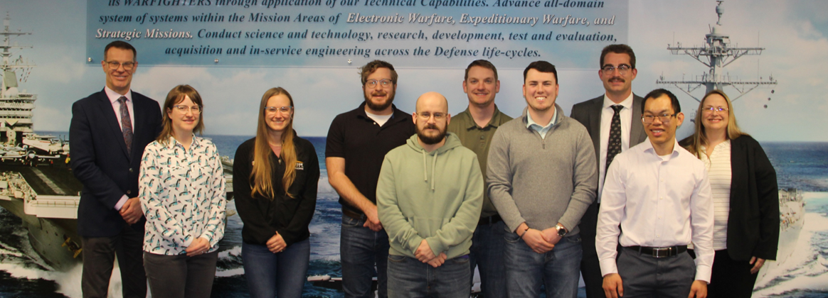 Group of Purdue University, NSWC Crane staff, and participating students photographed.